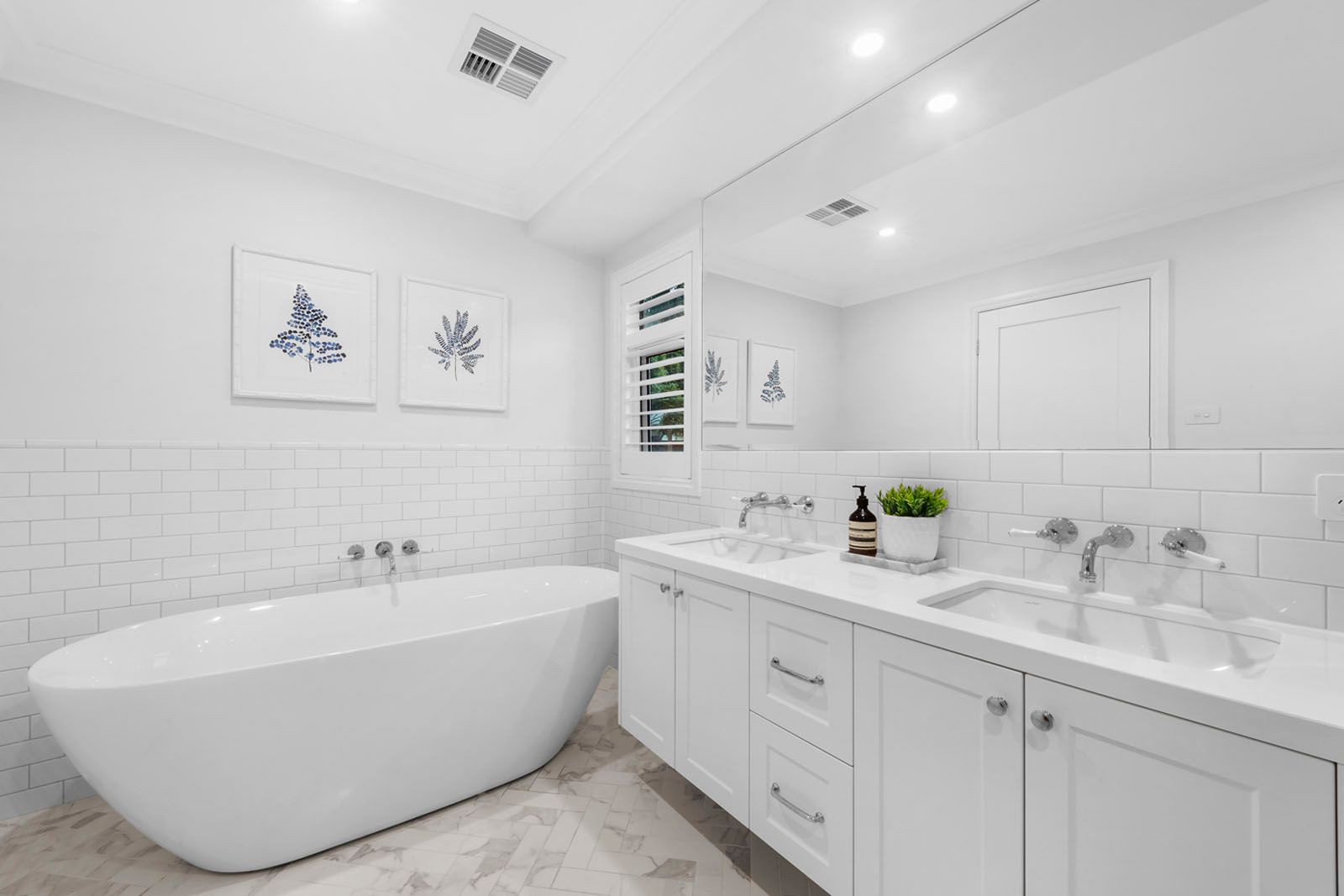 Bathroom with freestanding bath and subway tiles