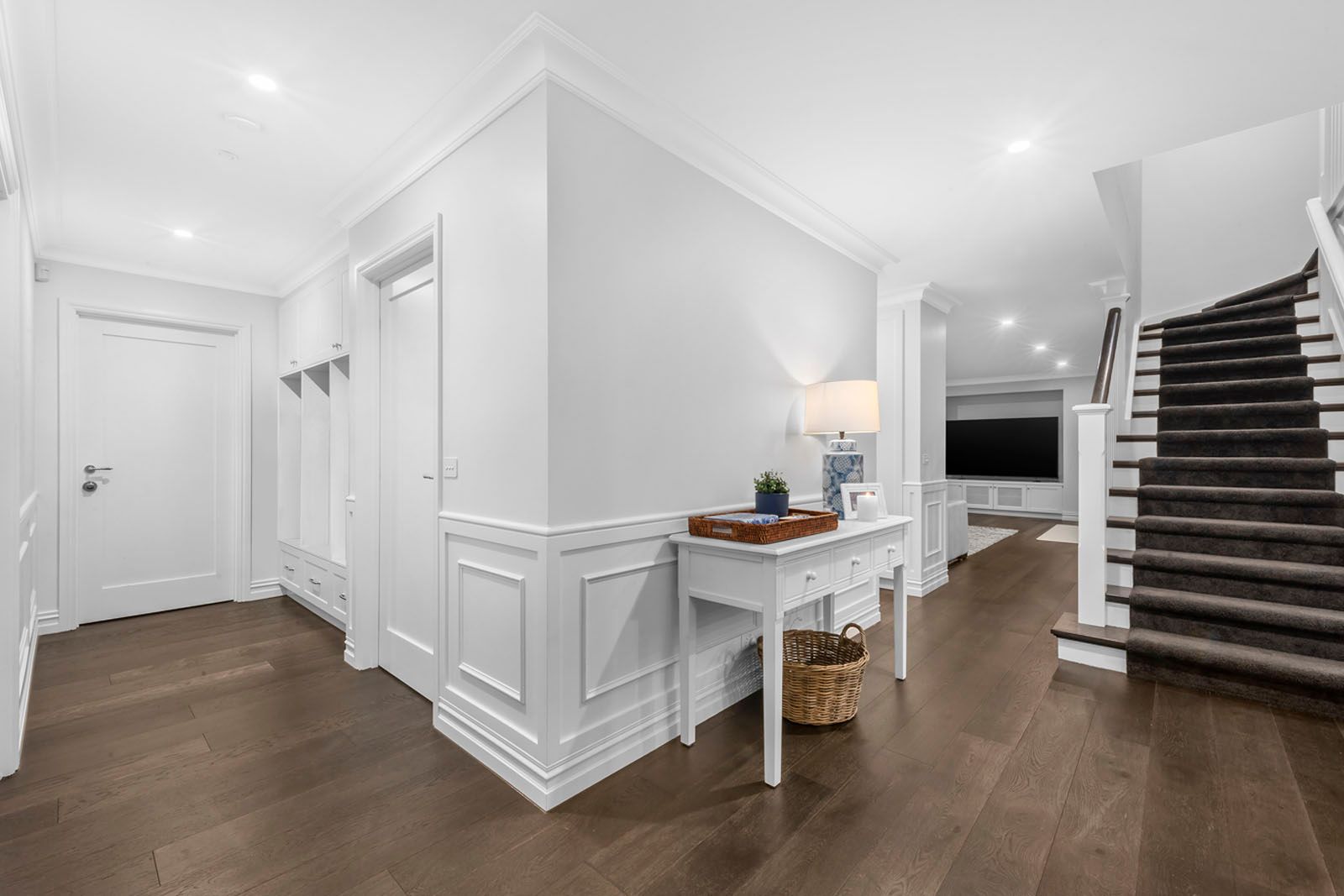 Entry hall with wainscoting and the staircase