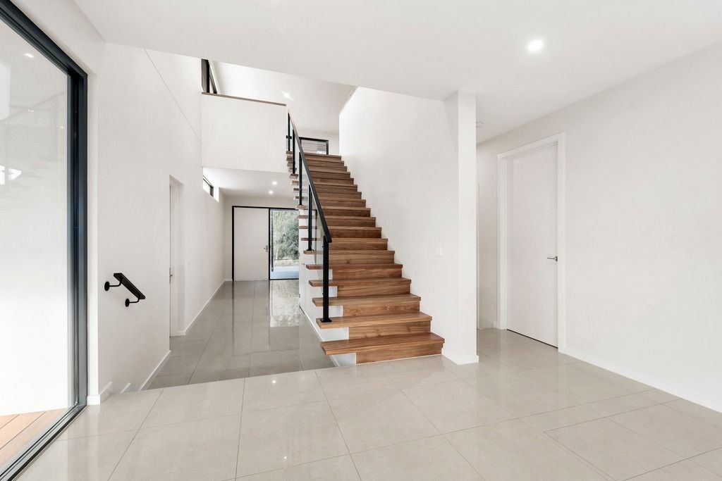 Entry and cantilevered timber staircase