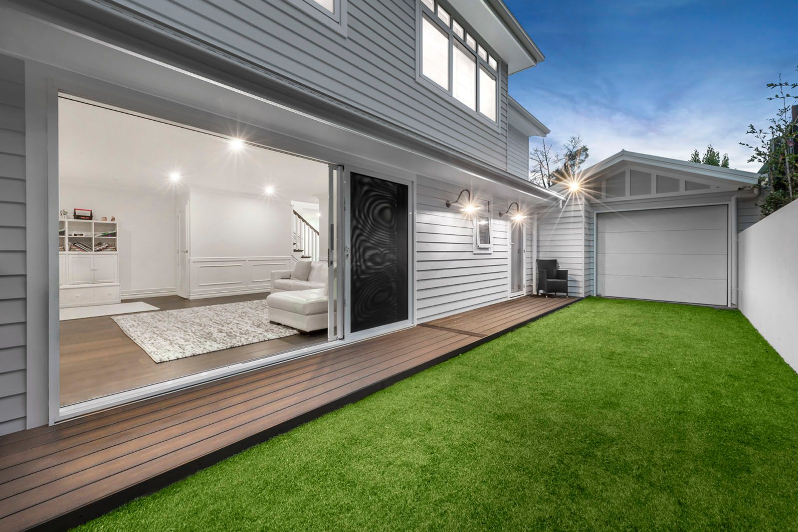 Living room opening onto the deck and lawn