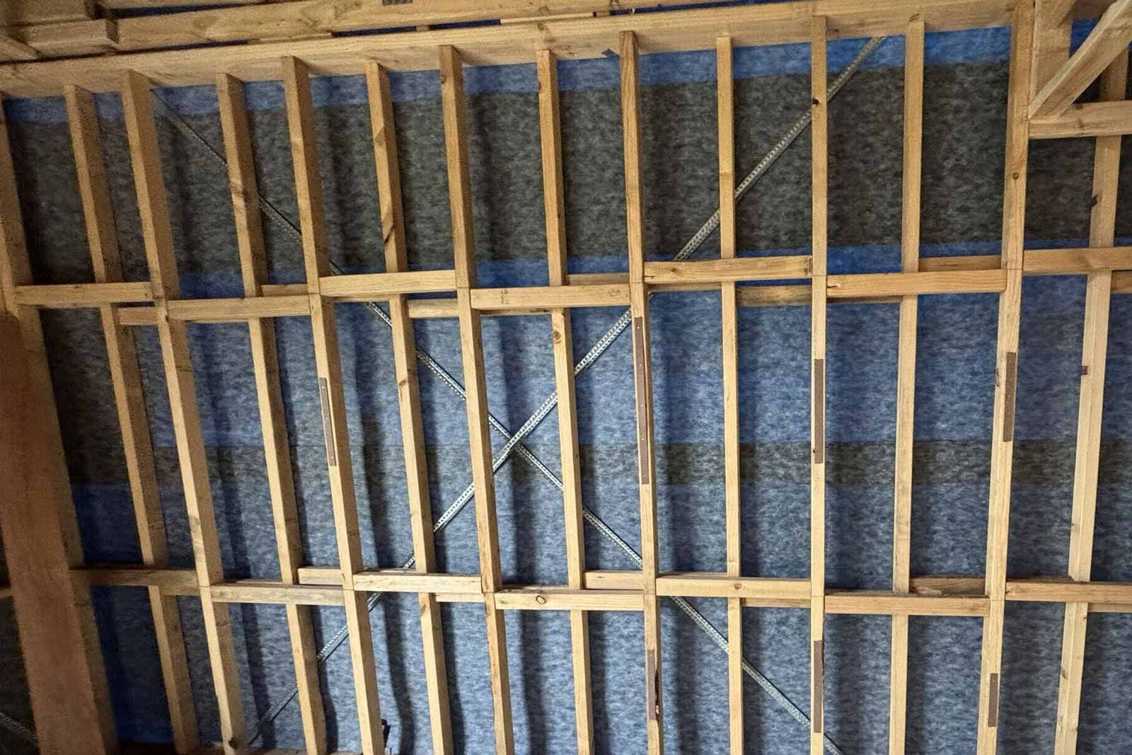 Ceiling framing with insulation and airtight membrane being installed