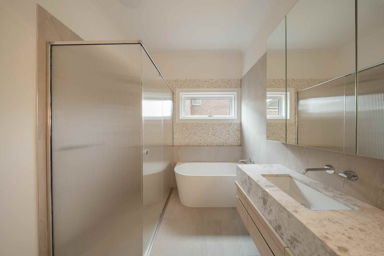 Bathroom with freestanding bath and stone vanity