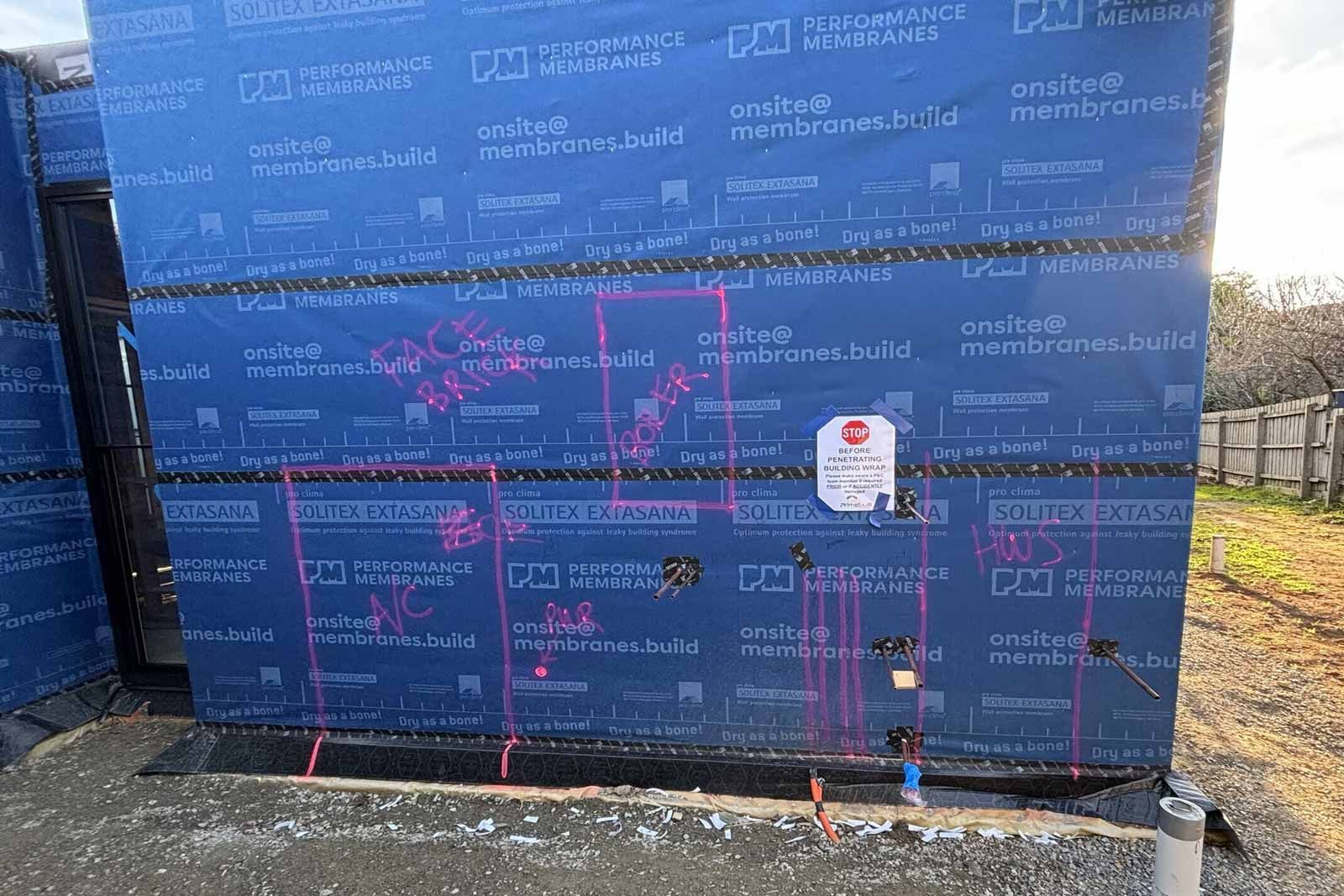 External walls wrapped in a weather-resistive membrane with taped joins