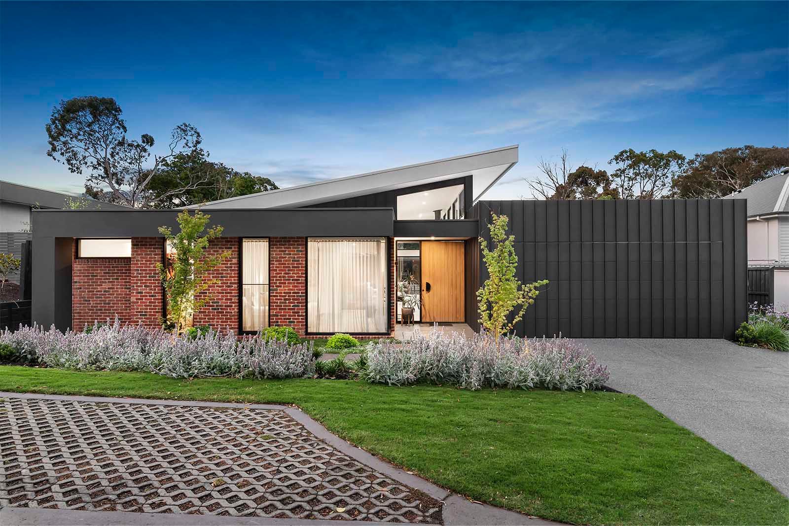 Street front with landscaped garden and dark cladding