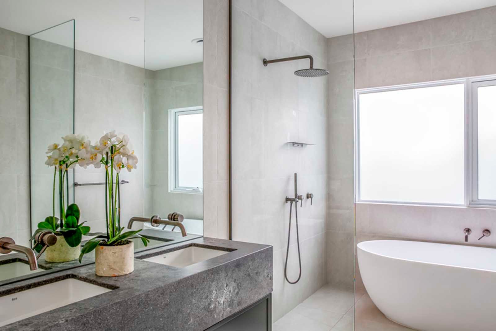 Bathroom with stone vanity and freestanding bath