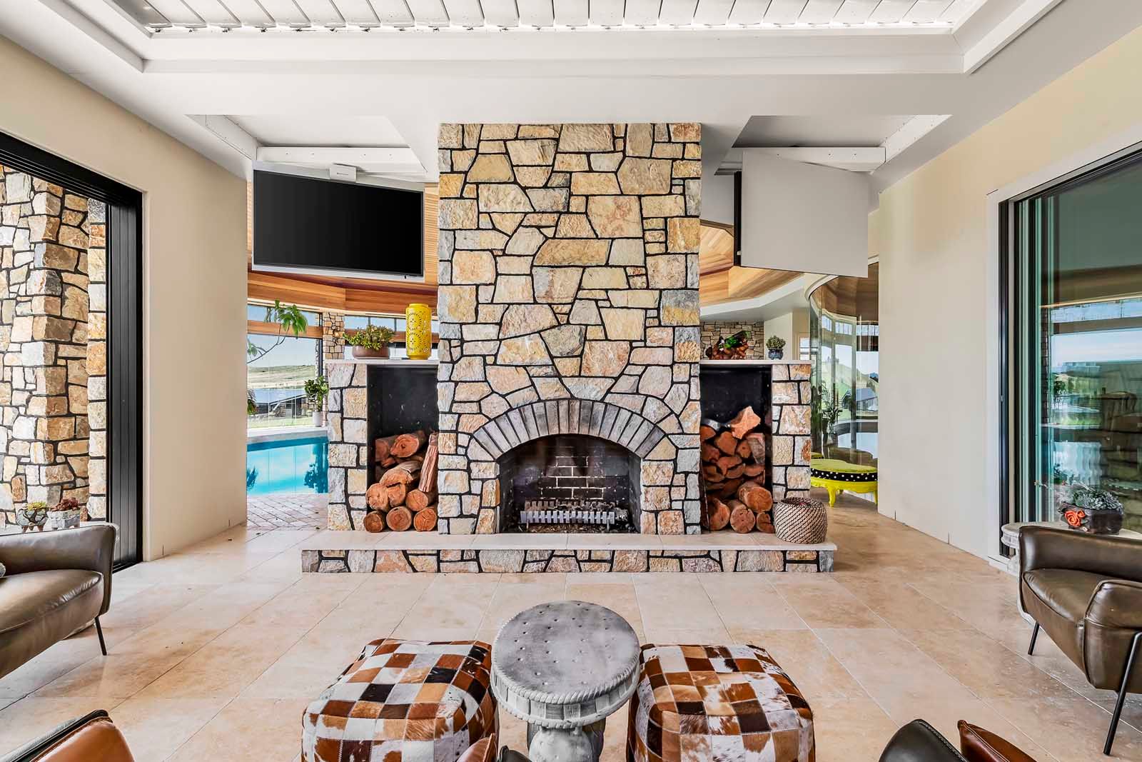 Living room with a stone fireplace and wide views