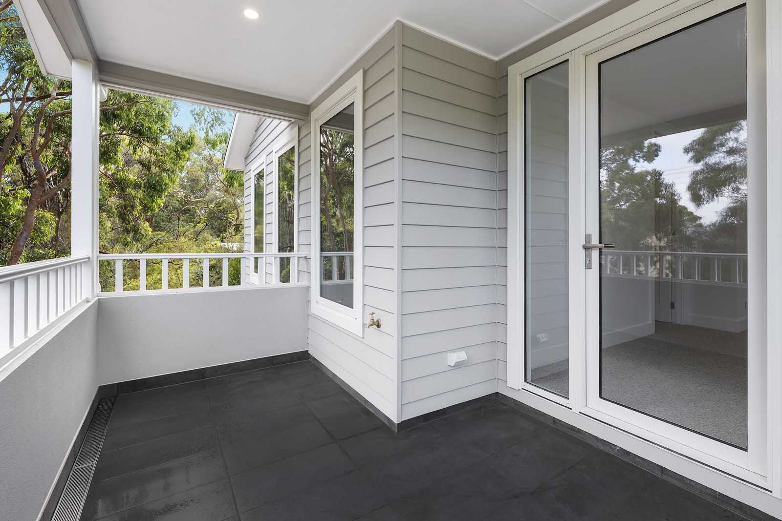 Covered balcony with weatherboard walls