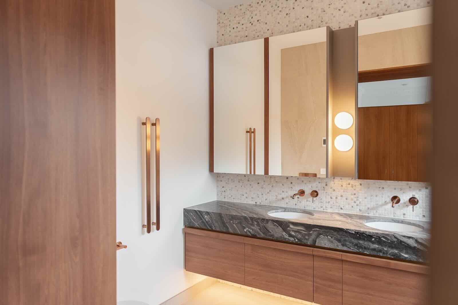 Vanity with dark stone top and timber cabinetry