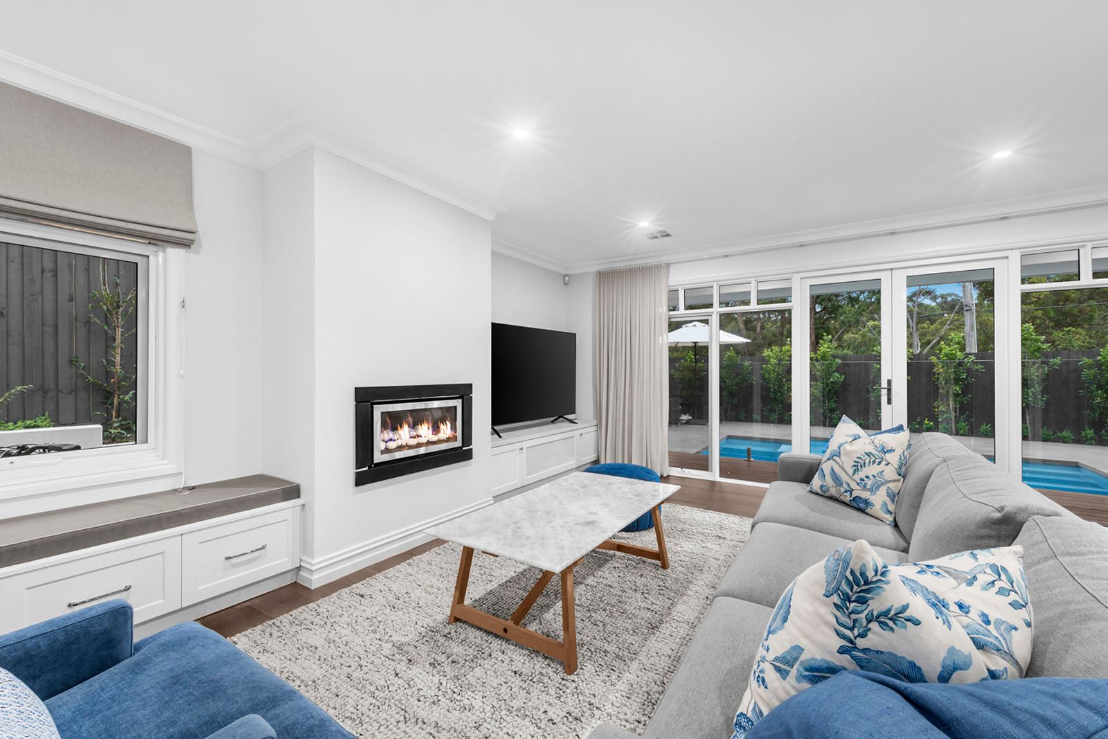Lounge with gas fireplace and views to the pool