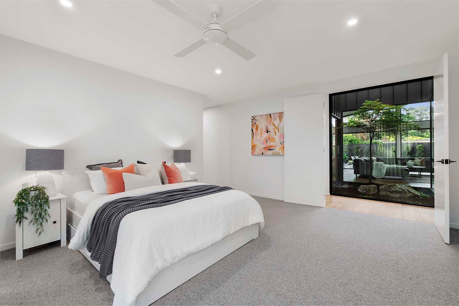 Bedroom with a large window to the garden