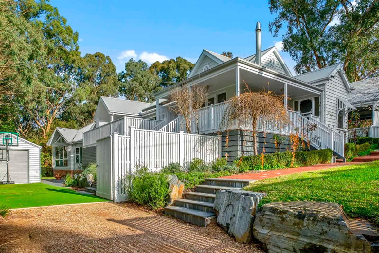 Mitcham on Quarry from the street: a weatherboard home with a deep verandah among established gum trees