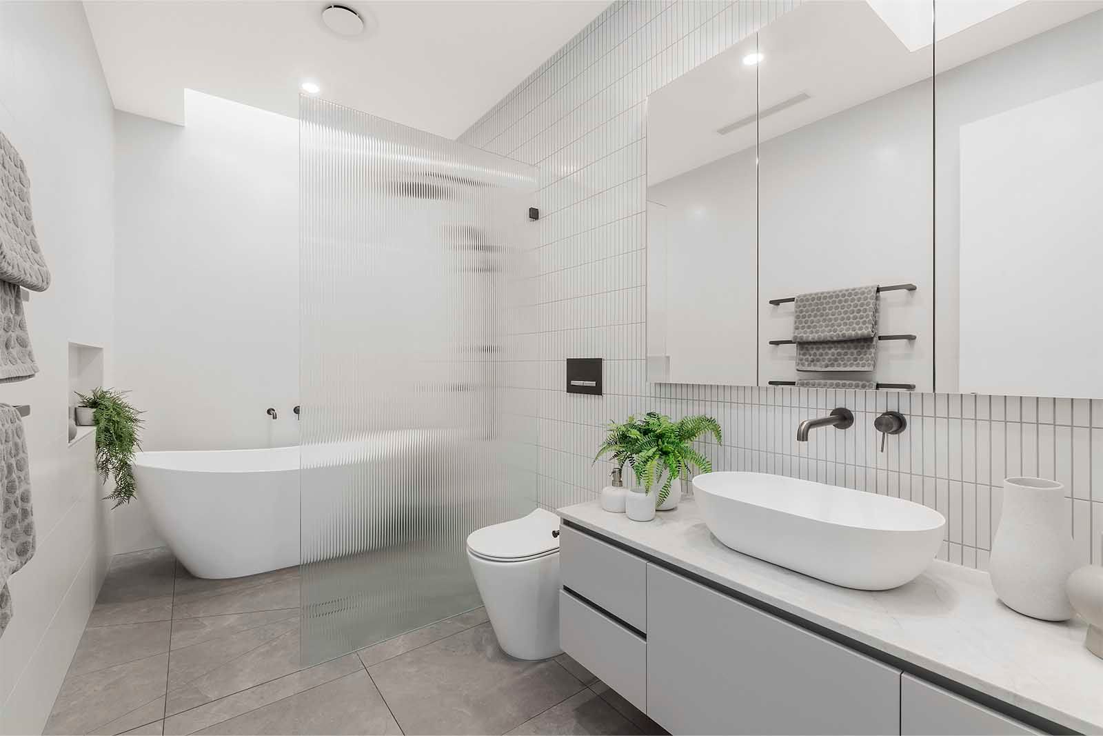 Bathroom with freestanding bath and stone vanity