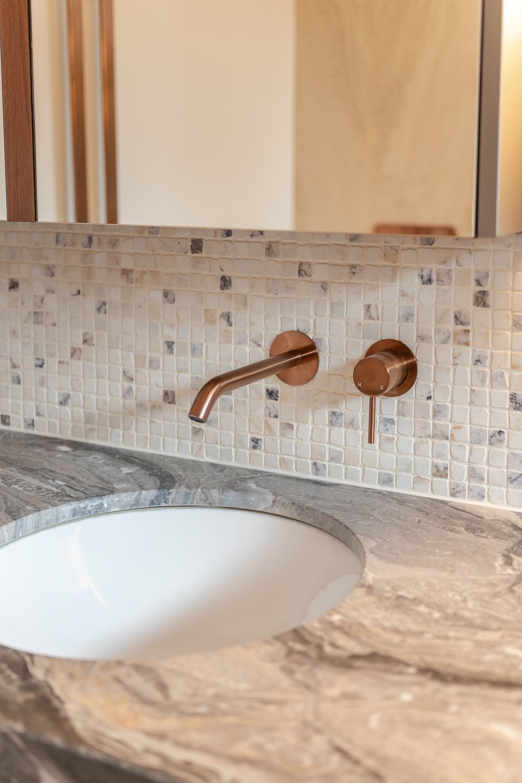 Copper tapware against mosaic tiles