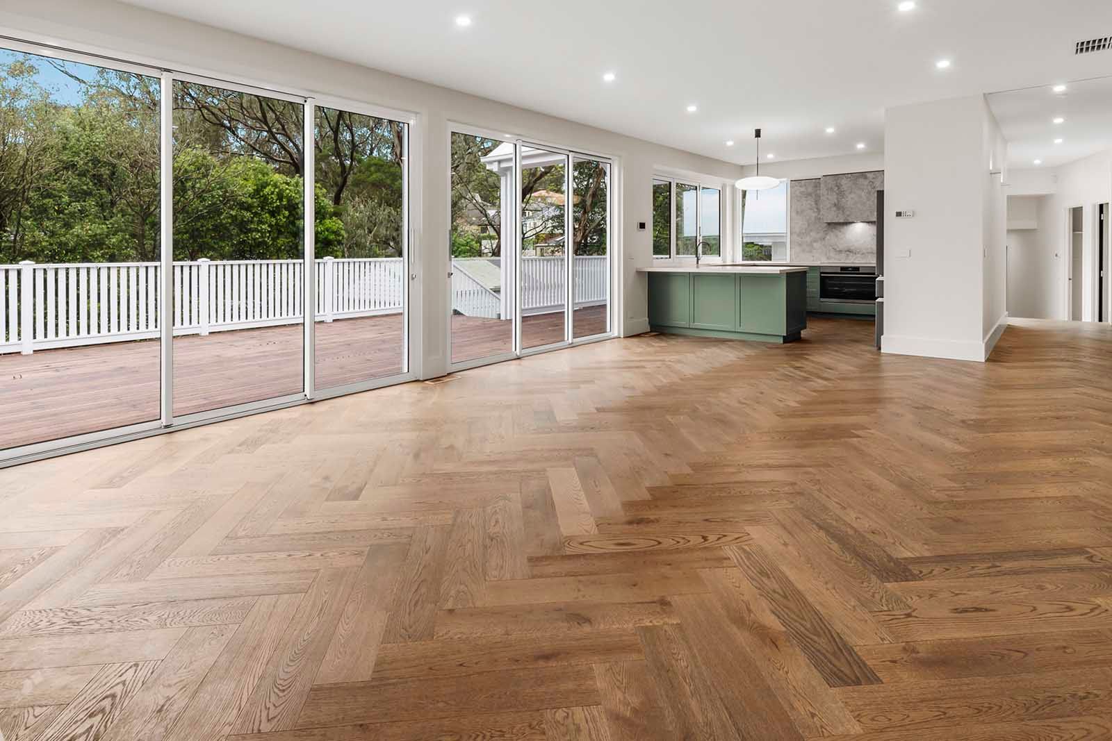 Herringbone timber floor running to glass doors and the deck