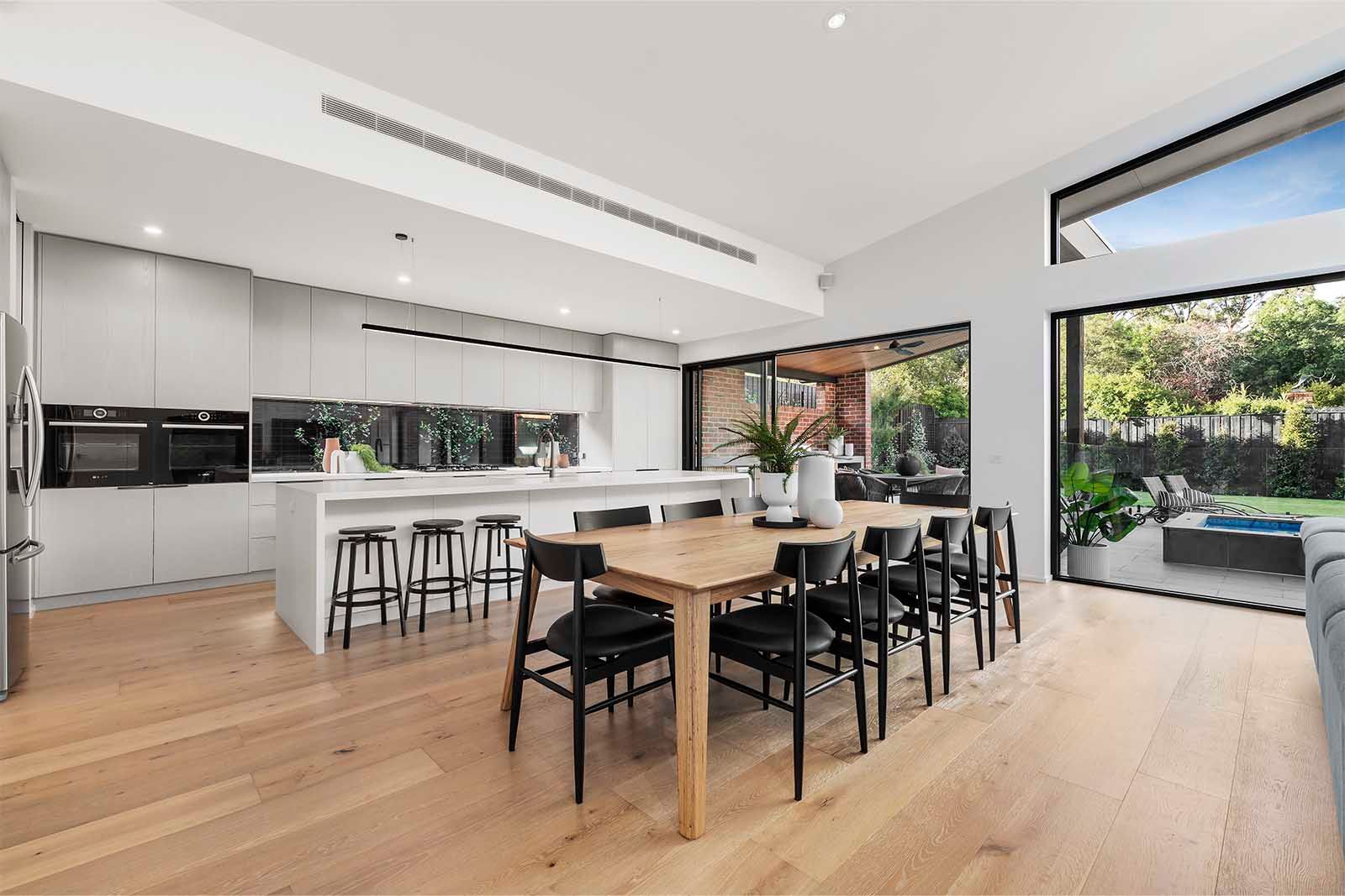 Kitchen island and dining table with garden views