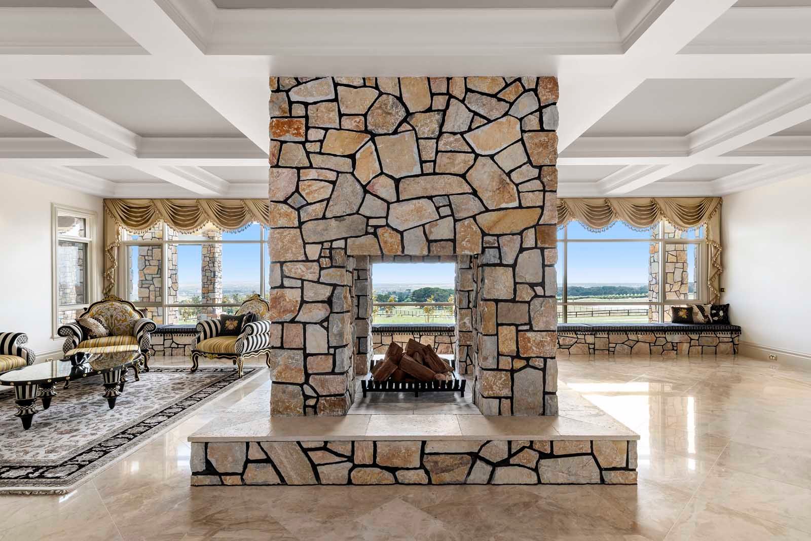 Formal lounge around a double-sided stone fireplace