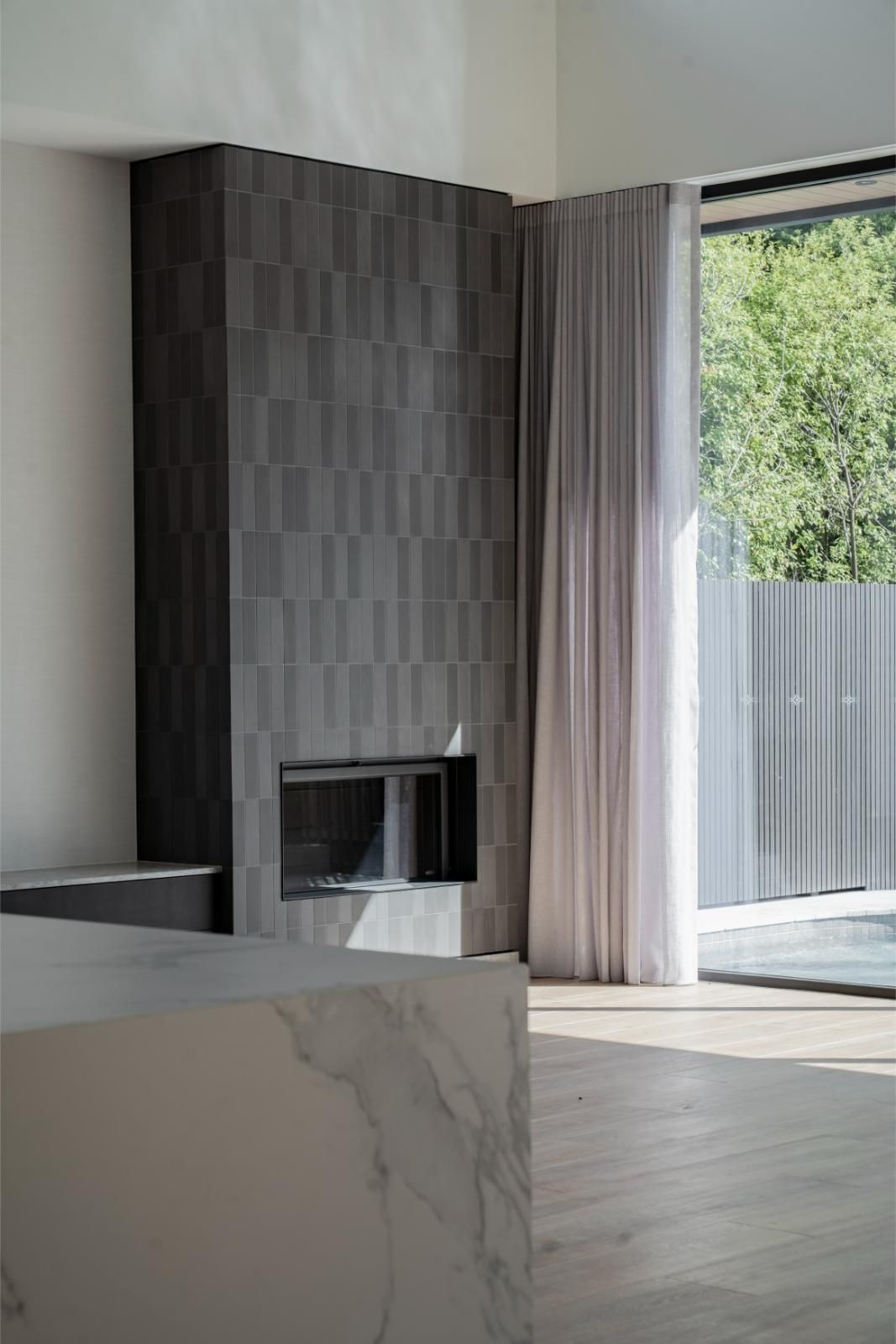 Living area with a tiled feature fireplace